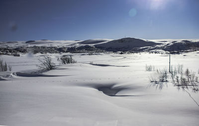 Scenic view of snow covered mountains against sky