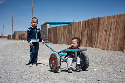 Full length portrait of boy riding motorcycle