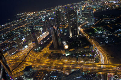 High angle view of city lit up at night