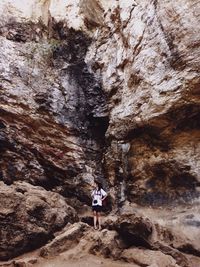 Full length of woman standing on rock formation