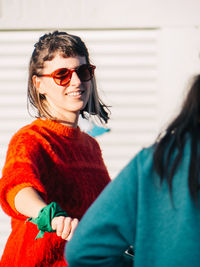 Portrait of smiling young woman wearing sunglasses