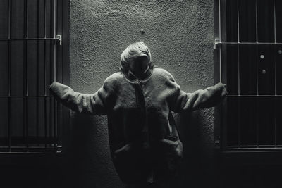 Full length of man standing against wall