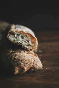 Close-up of bread on table against black background