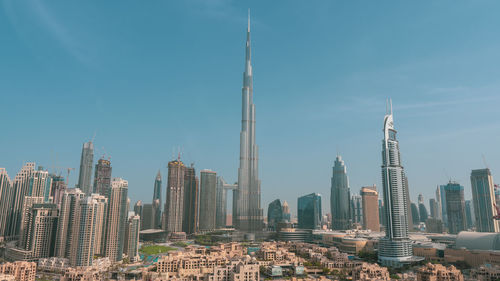 Panoramic view of buildings in city against sky