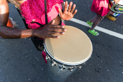 Midsection of man playing drum