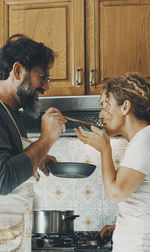 Side view of man preparing food at home