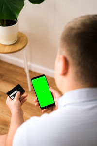 A man makes an online order on a mobile phone with a green screen. green screen phone background