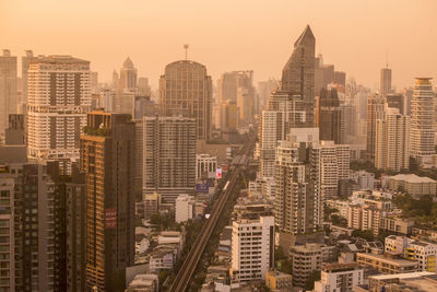 Aerial view of modern buildings in city against sky