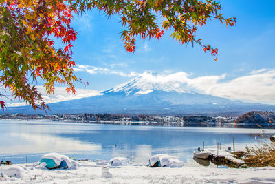 Scenic view of sea by mountains against sky