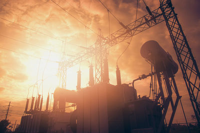 Low angle view of construction site against sky during sunset