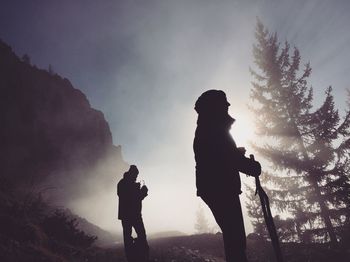 Silhouette of couple on mountain