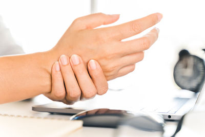 Close-up of woman hand on table