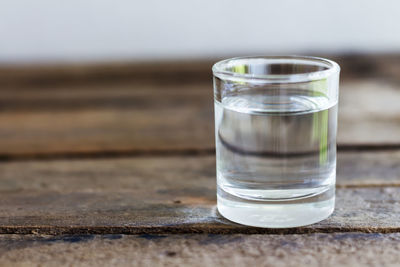 Close-up of water in drinking glass on wooden table