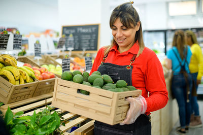 Smiling woman working in grocery store