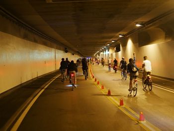 People riding bicycle in tunnel