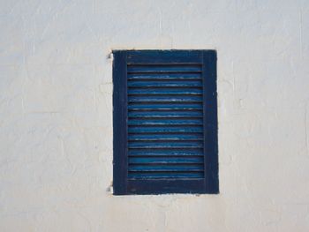 Low angle view of window on wall of building