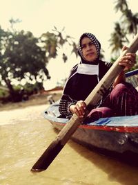 Portrait of a girl sitting on shore