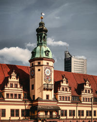 Low angle view of clock tower against buildings in city