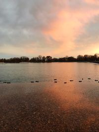 Scenic view of lake against sky during sunset