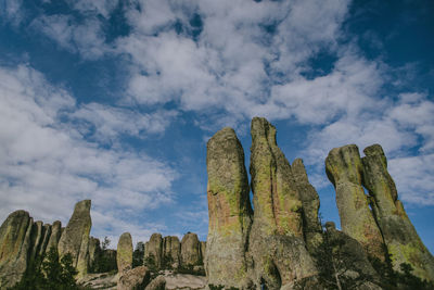 Low angle view of rock formations against sky