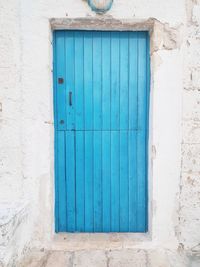 Closed blue door of old building