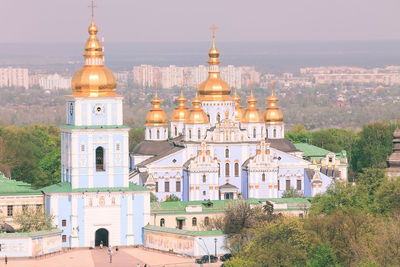 Blue orthodox cathedral with cityscape in kiev, ukraine.