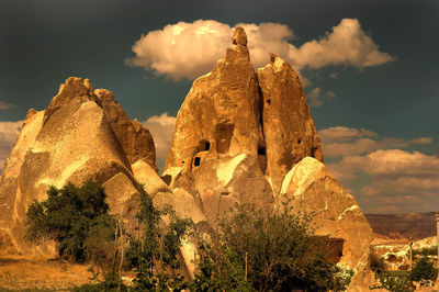 Panoramic view of rock formation against cloudy sky