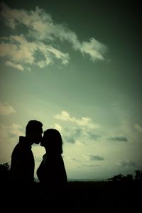 Silhouette couple against sky during sunset