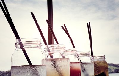 Drinks in jar against sky