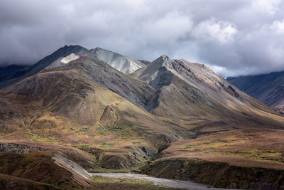 Scenic view of mountains against cloudy sky