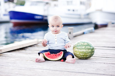 Cute baby boy eating watermelon outdoors. summer season.