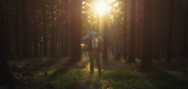 Man in forest at sunset