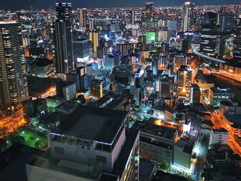 High angle view of illuminated city buildings at night