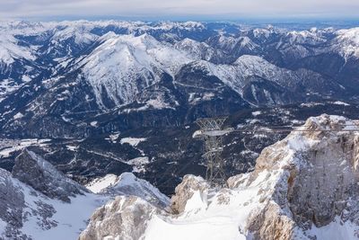 Aerial view of snowcapped mountains against sky