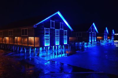 Illuminated building in water at night