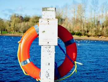 Close-up of umbrella on lake against sky