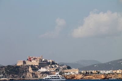 View of town against cloudy sky