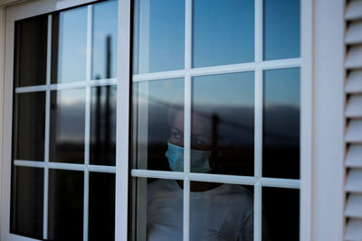 People standing by window in building