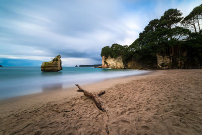 View of beach against cloudy sky