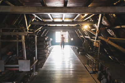 Rear view of woman walking on staircase in building