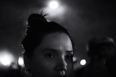 Close-up portrait of woman at night