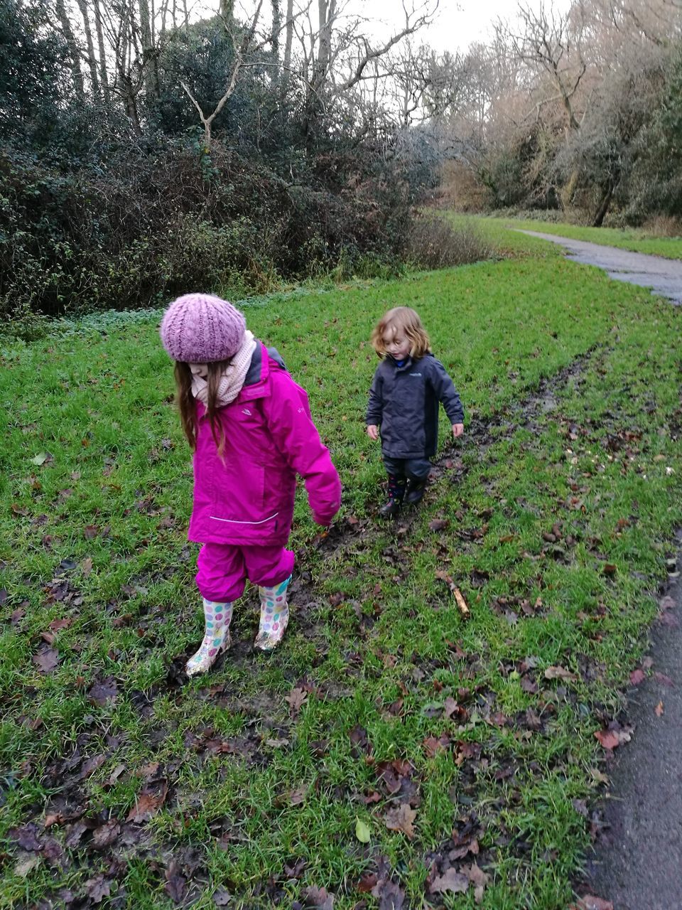 childhood, full length, girls, two people, walking, knit hat, togetherness, child, day, warm clothing, outdoors, grass, growth, tree, real people, standing, nature, children only, people