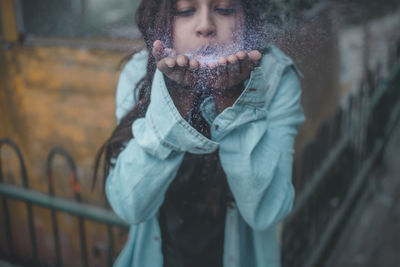 Close-up of young woman standing in snow