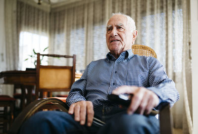 Portrait of senior man watching television at home