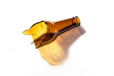 Close-up of yellow bottle against white background