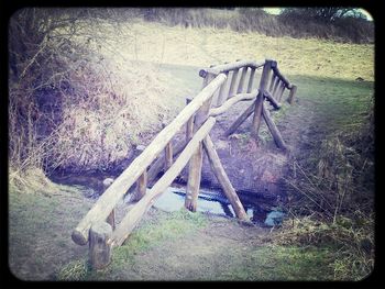 Empty bench on grassy field