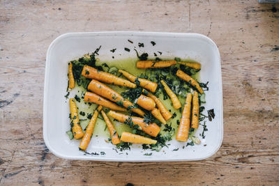 High angle view of healthy roasted carrots on plate