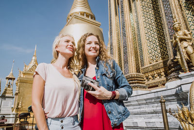 Happy women at temple in city