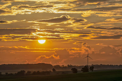 Scenic view of field against romantic sky at sunset