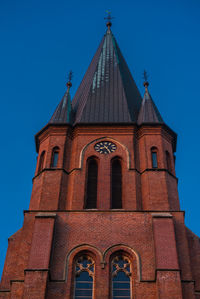 Low angle view of building against clear blue sky